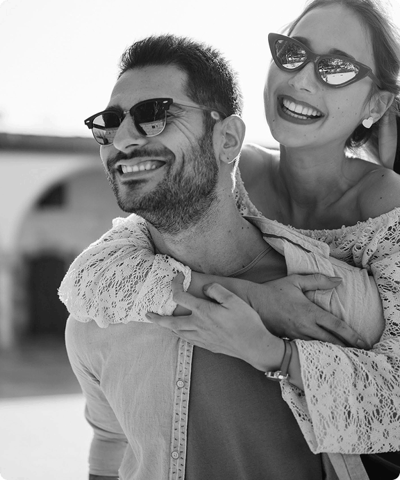 Smiling couple wearing sunglasses